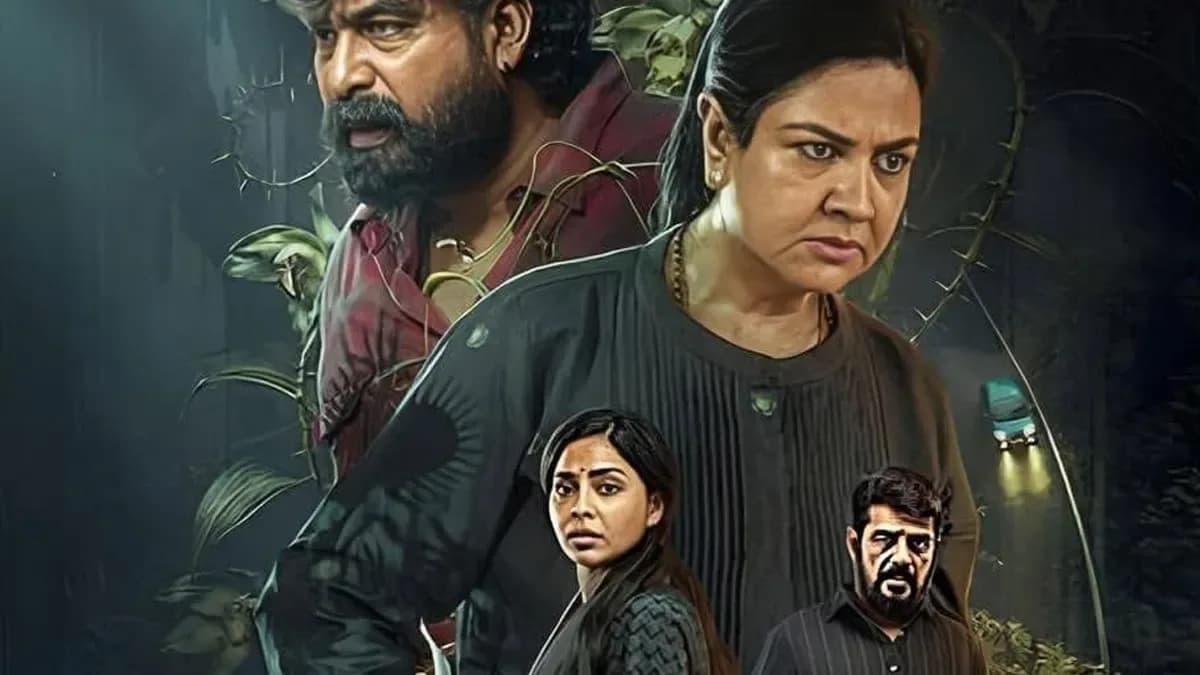 Still from Aasha featuring Urvashi, Joju George, and Aishwarya Lekshmi in a dramatic scene set in a dimly lit room.