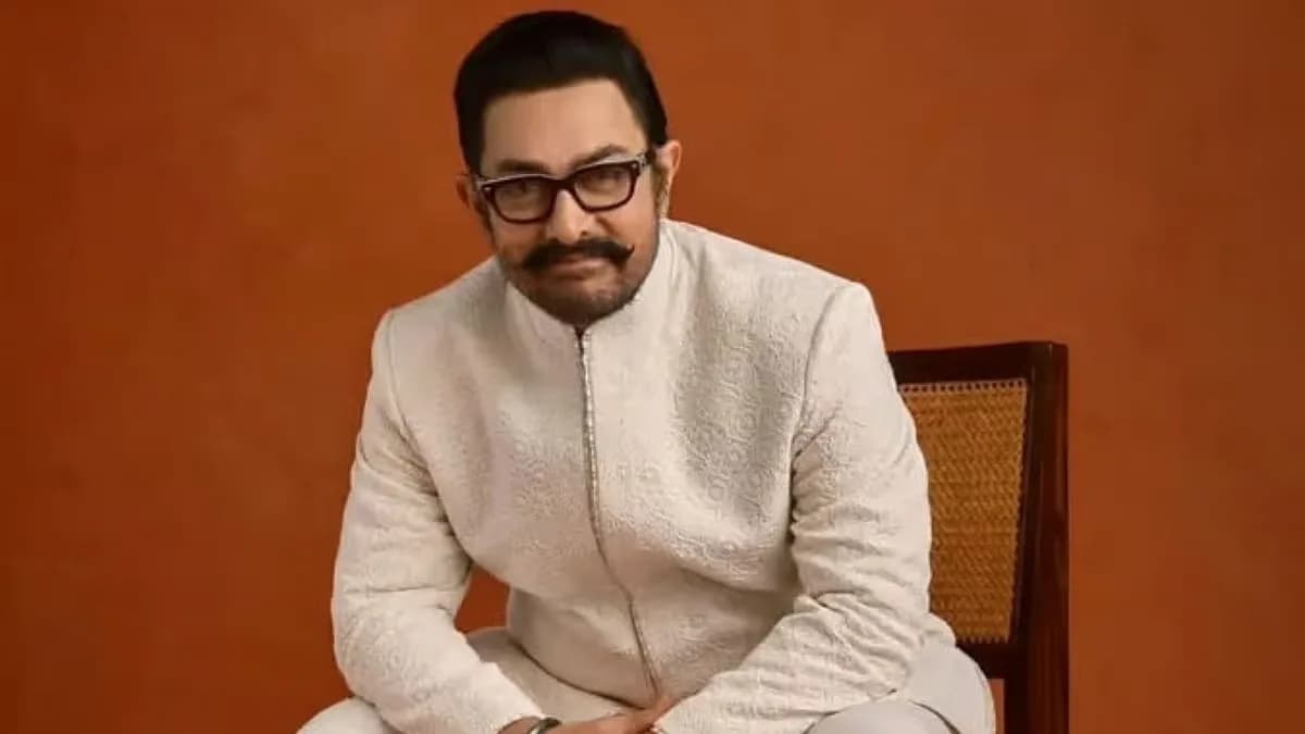 Aamir Khan at a public event, smiling and looking off camera