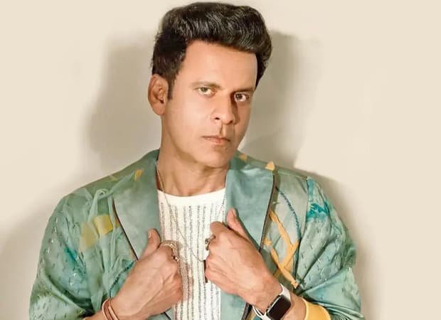 Manoj Bajpayee standing in a courtroom with legal documents spread on a table