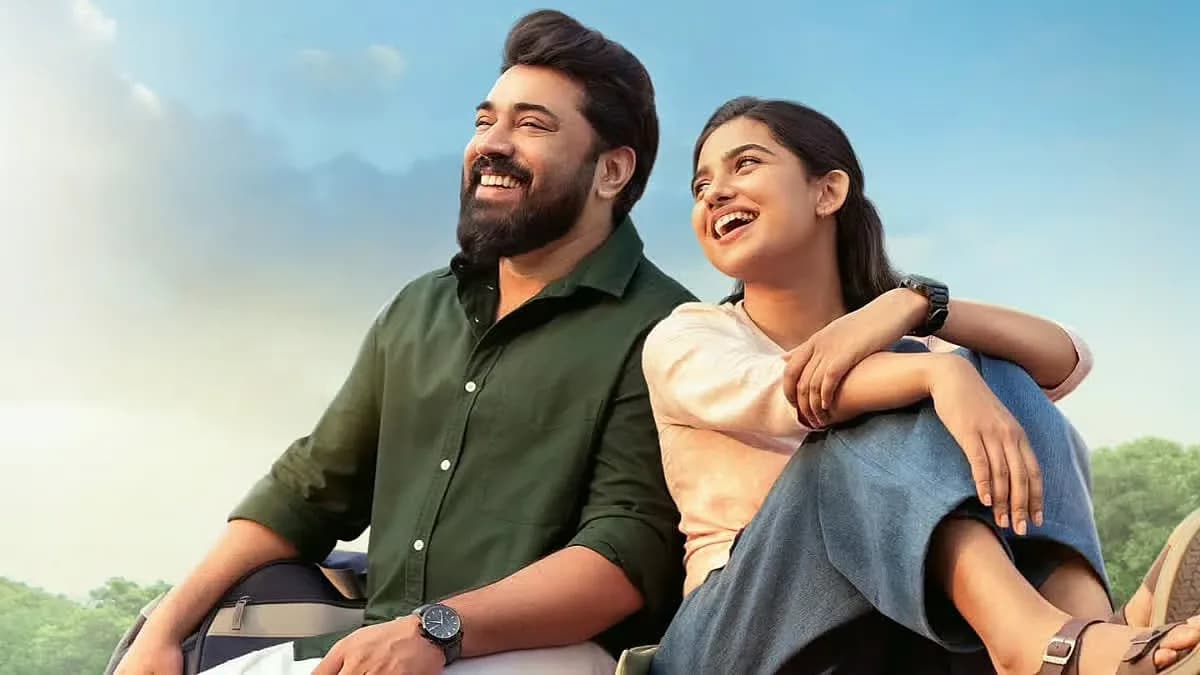 A still from Bethlehem Kudumba Unit showing Nivin Pauly and Mamitha Baiju in a quiet moment on a balcony.
