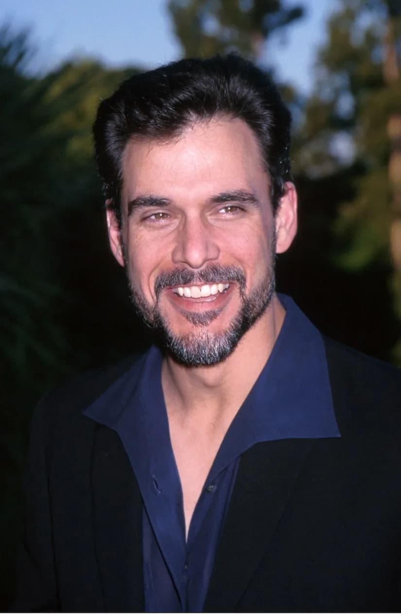 Portrait of Robert Kelker-Kelly as Bo Brady on Days of Our Lives, mid-speech, wearing a blue shirt.