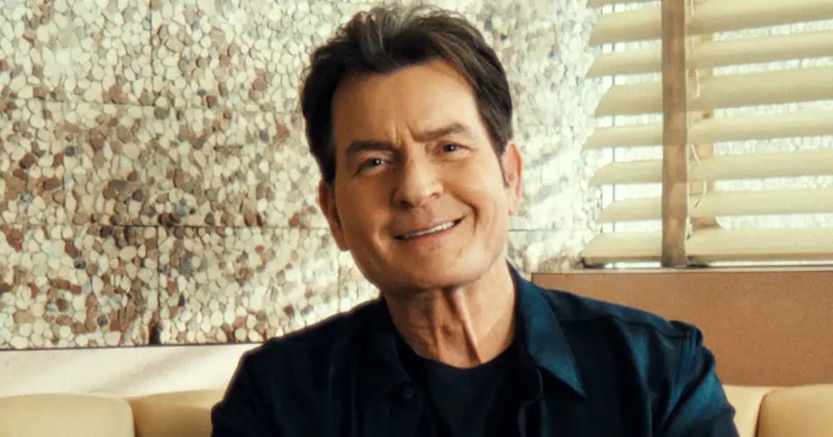 Charlie Sheen and Martin Sheen side by side at a public event, both smiling at the camera.