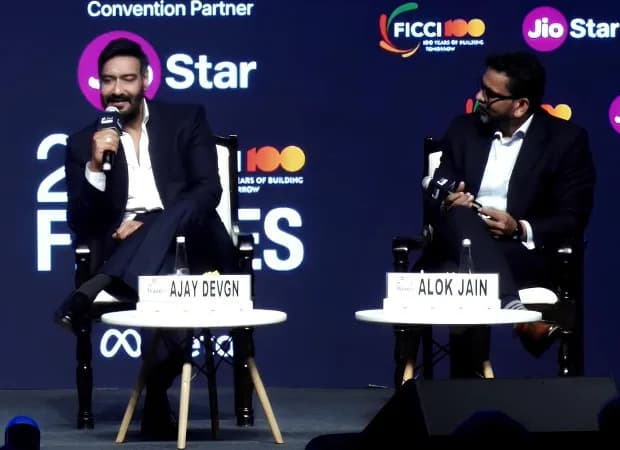 Ajay Devgn speaking at the FICCI Frames 2026 conference, with a backdrop displaying the Drishyam The Conclusion logo.