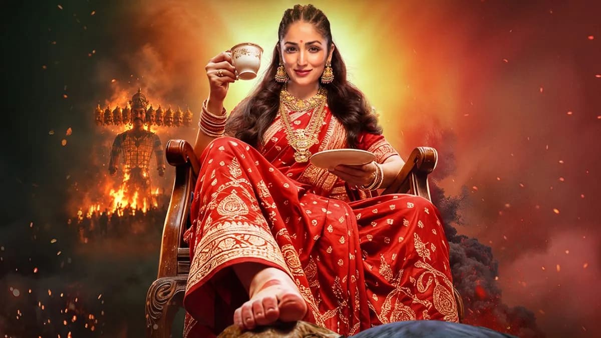 Yami Gautam in a vibrant costume holding a broom, with a stylized Raavan figure in the background, from the Nayyi Navelli trailer.