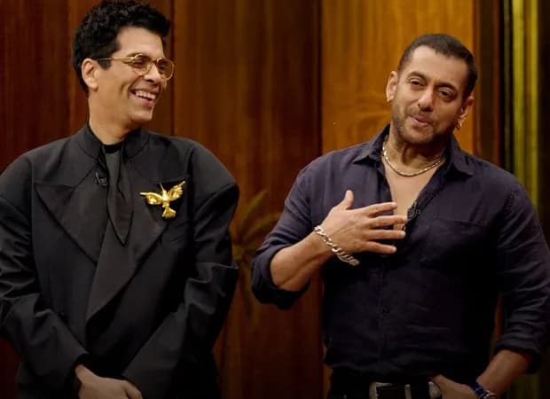 Salman Khan sitting on the Koffee With Karan couch, smiling at Karan Johar
