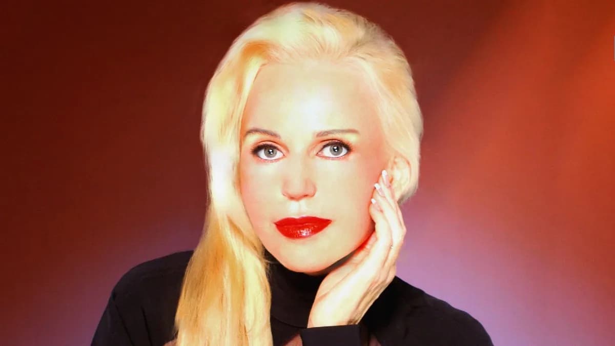 Brenda Dickson seated for a portrait, looking directly at the camera, with a neutral background.