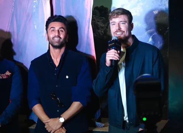 Ranbir Kapoor and MrBeast on stage at the Ramayana film launch in Mumbai, with the audience cheering.
