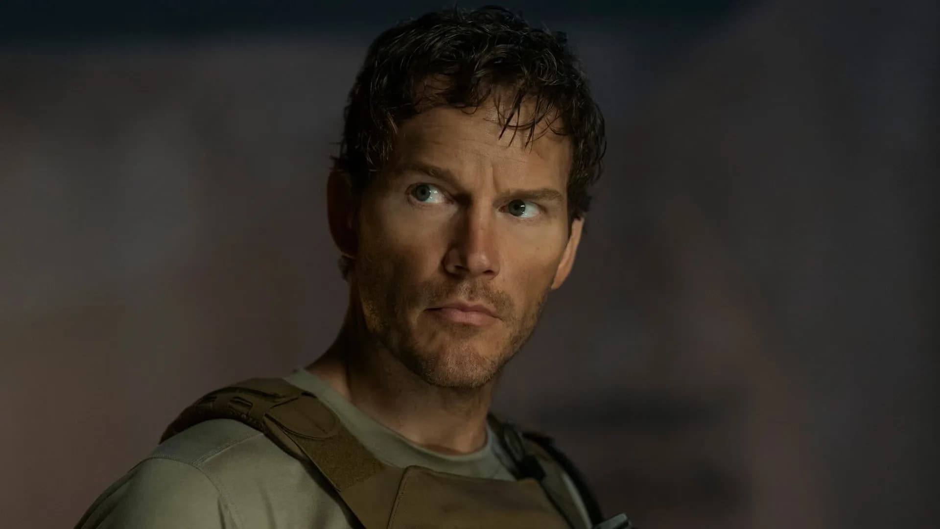 Chris Pratt as James Reece, looking tense, standing in a desert landscape under a red sky.