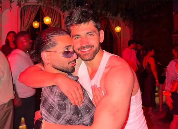 Avinash Mishra holding the Khatron Ke Khiladi 15 trophy at his victory party, surrounded by cast members including Orry, Shagun Sharma, and Karan Wahi.