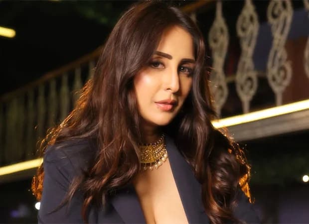 Chahatt Khanna speaking in a studio interview, wearing a teal top