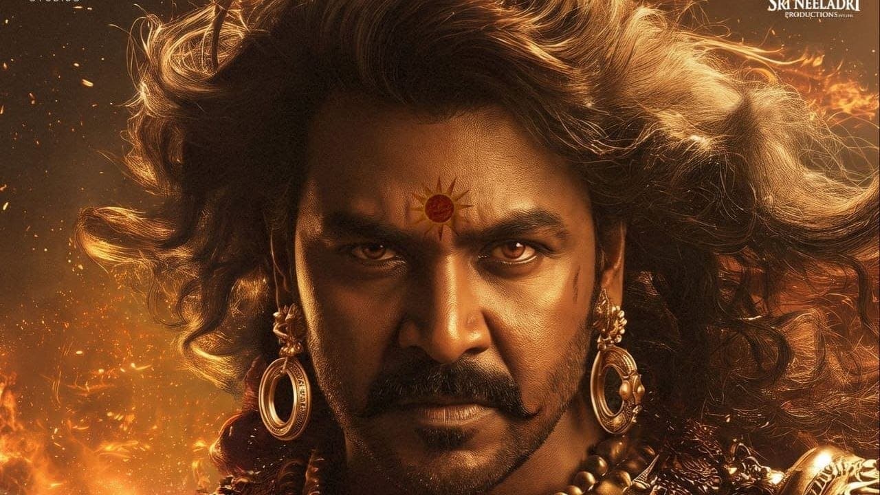 Poster of Raghava Lawrence as Karna in royal war attire with a sun emblem on his forehead, for the film Mahaveer Karna.