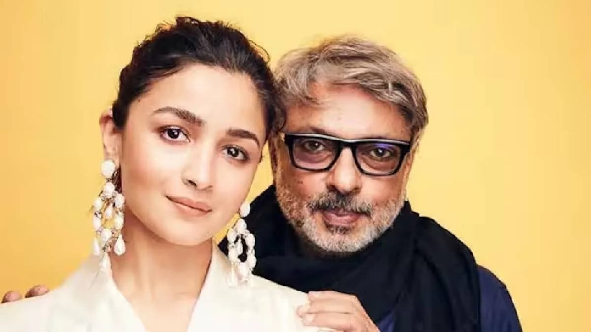Alia Bhatt and Sanjay Leela Bhansali in a studio setting, looking at script pages together