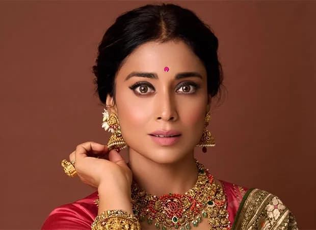 Shriya Saran in a blue polka dot dress, promoting Drishyam 2
