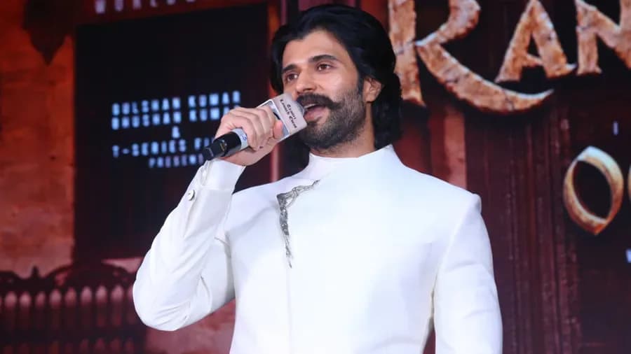 Vijay Deverakonda at the Ranabaali trailer launch in Hyderabad, standing tall in traditional warrior attire, facing the camera with intensity.