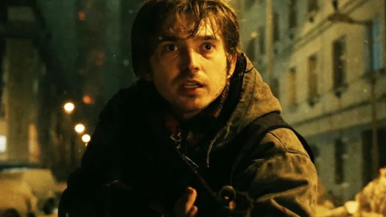 Poster of Resident Evil featuring Austin Abrams and Zach Cherry against a dark Raccoon City backdrop