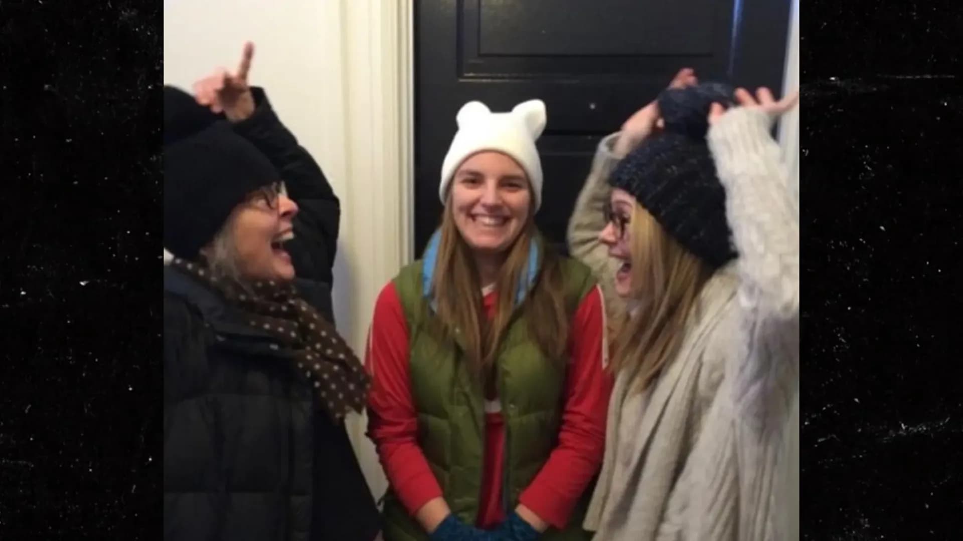 Diane Keaton and Sarah Paulson laughing together outdoors in winter coats, with Keaton's daughter Dexter White nearby.