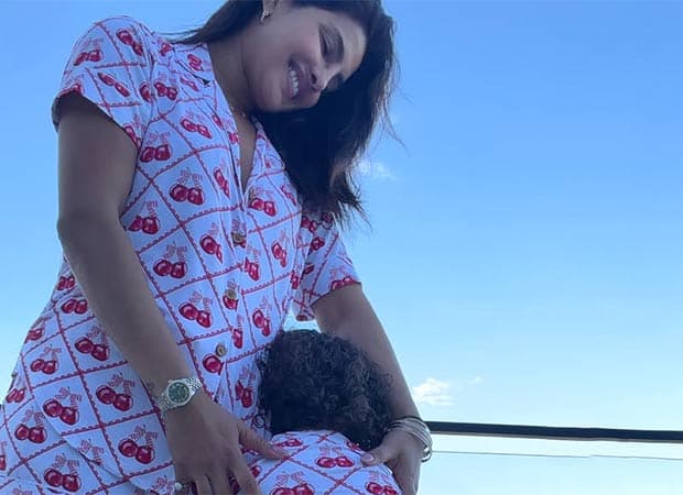 Priyanka Chopra Jonas embracing her daughter Malti Marie, both wearing matching white outfits with a red cherry print.