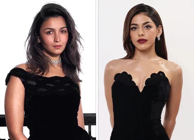 Alia Bhatt in a black off-shoulder midi dress, standing in front of a reflective surface, wearing diamond earrings and stilettos.