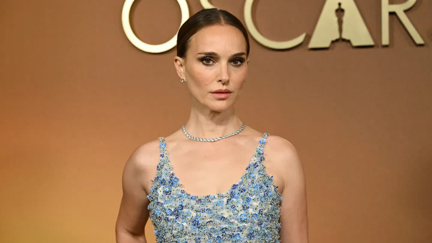 Natalie Portman smiling at a public event before the birth of her third child