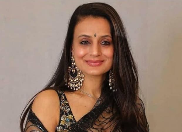 Ameesha Patel speaking during a social media live session, gesturing while discussing film promotion expenses