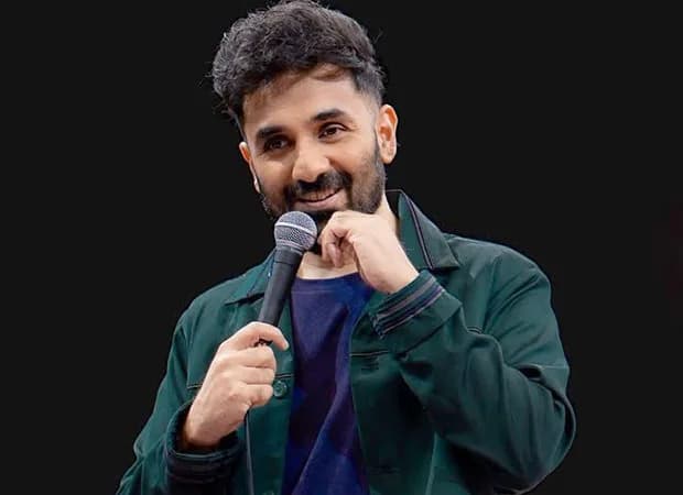 Comedian Vir Das performing on stage during his Netflix stand-up special.
