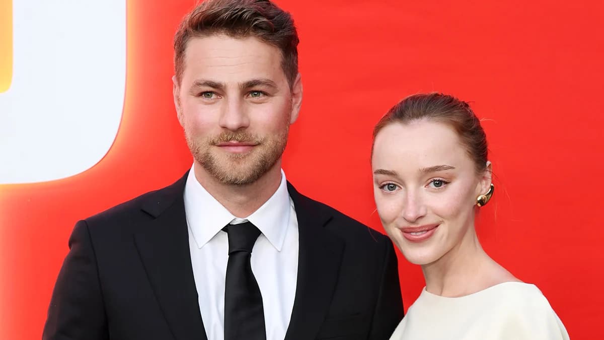 Black-and-white wedding photo of Phoebe Dynevor in a strapless Louis Vuitton gown with Cameron Fuller at their Provence ceremony.