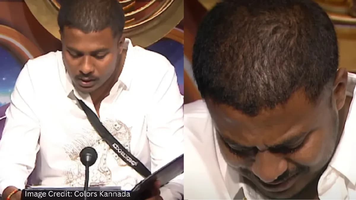 Manjunath in the Confession Room, eyes red, holding a note, looking emotional after hearing his mother's message on Bigg Boss Kannada Season 13.