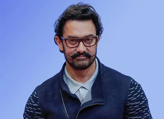 Aamir Khan smiling at a public event, associated with his Lagaan anniversary honour at the Singapore International Film Festival
