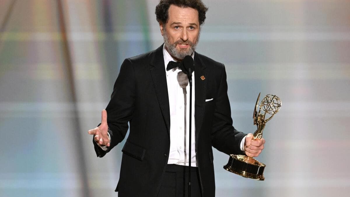 Matthew Rhys holding an Emmy award trophy on stage at the 2026 Emmy Awards ceremony
