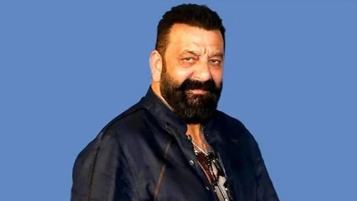 Sanjay Dutt walking through a crowded airport, looking tense.