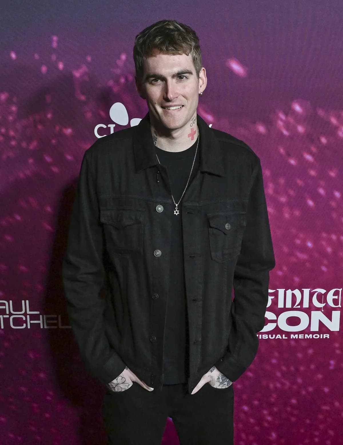 Presley Gerber at a public event, wearing a dark jacket and looking away from the camera