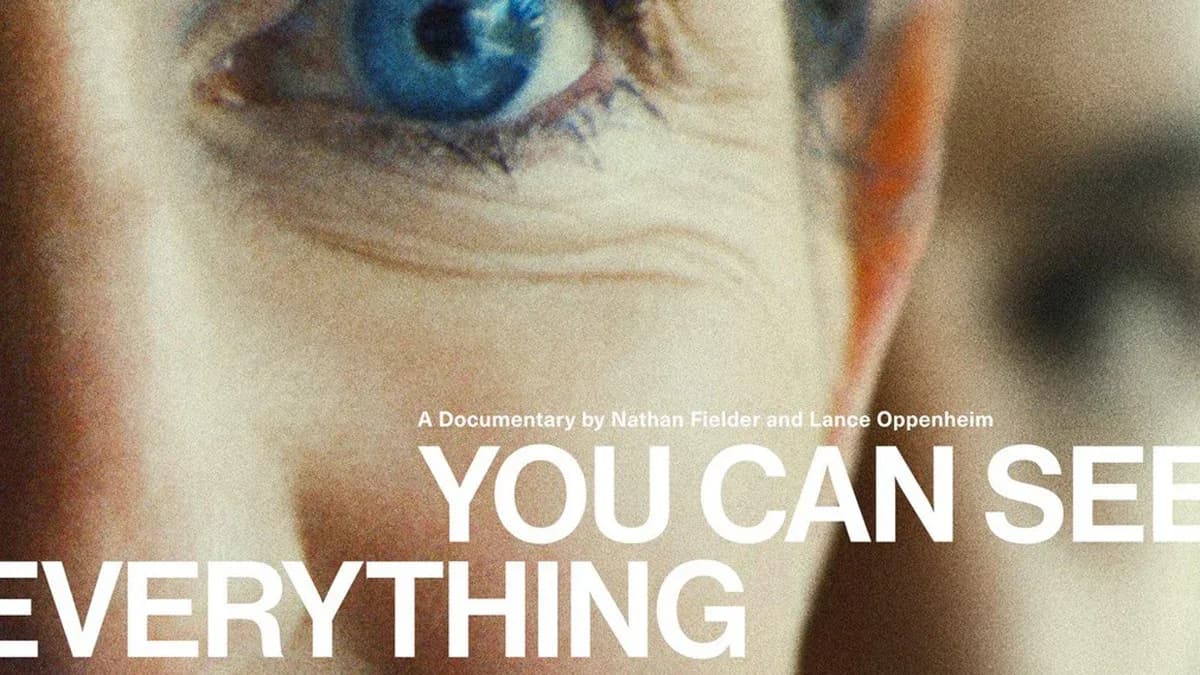 A black-and-white still from the documentary You Can See Everything, showing Elizabeth Holmes looking directly into the camera.