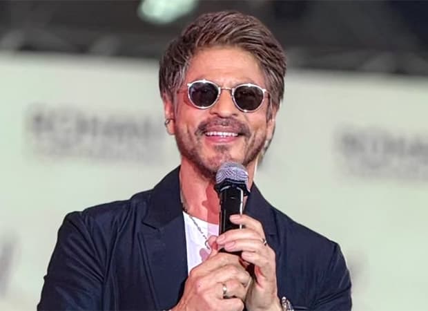 Shah Rukh Khan smiling during a public appearance, promoting his upcoming film King