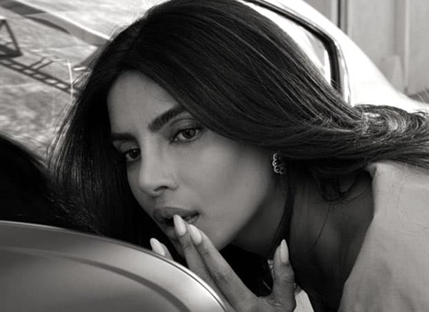 Priyanka Chopra Jonas sitting behind the wheel of a Bentley car during a behind-the-scenes campaign shoot.