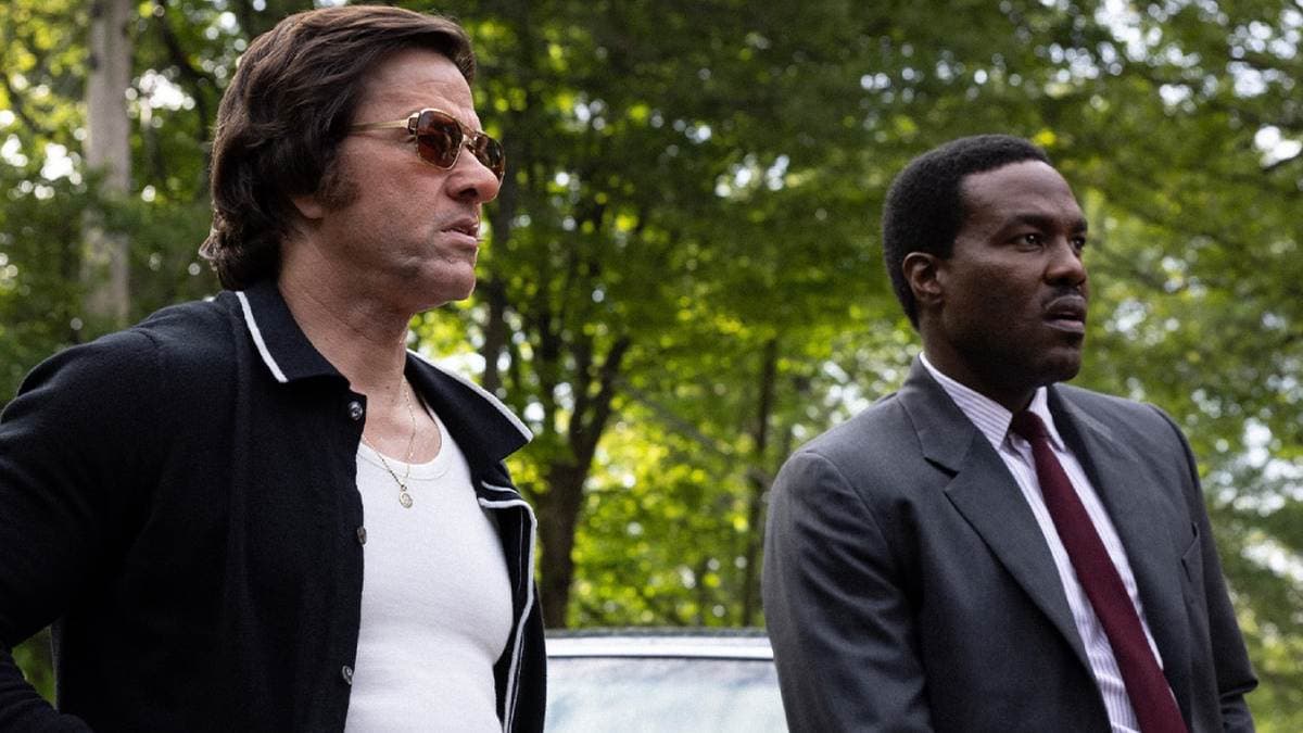 Promotional image for By Any Means featuring Yahya Abdul-Mateen II and Mark Wahlberg in a tense confrontation scene set in 1960s Mississippi.