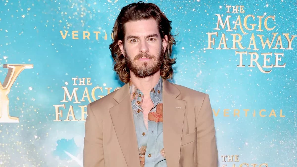 Andrew Garfield in a suit, looking thoughtful