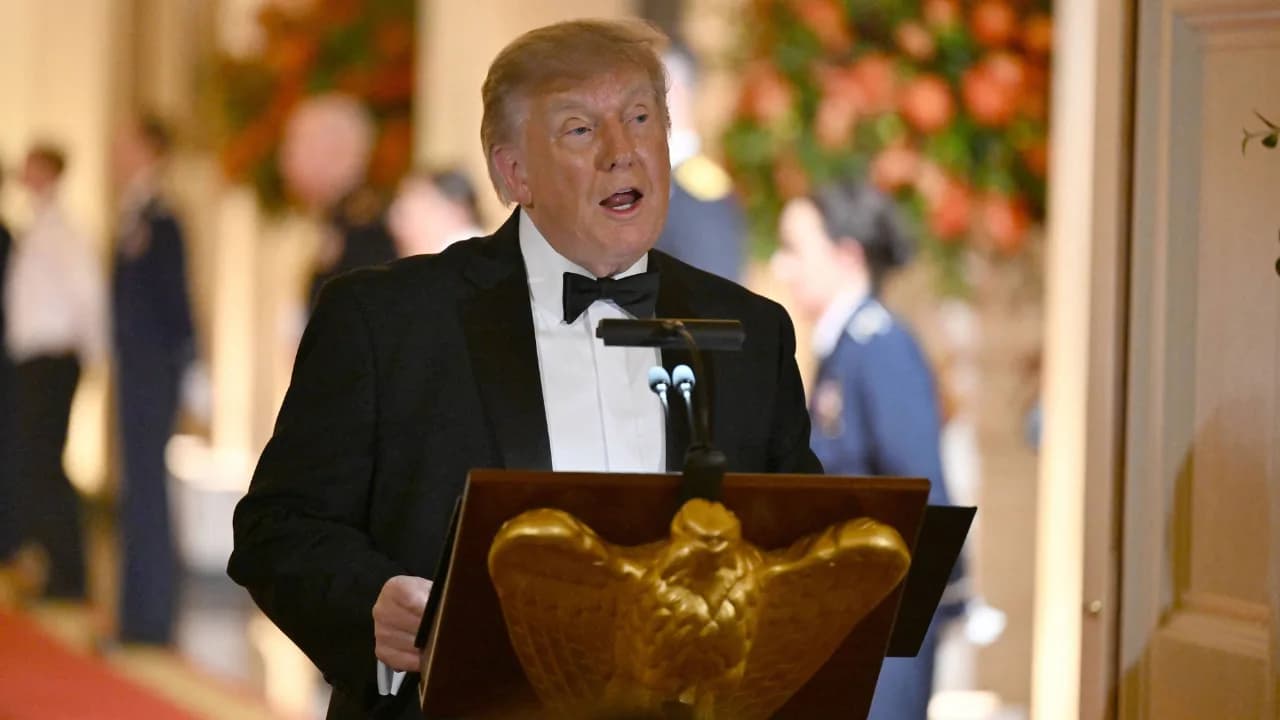 Donald Trump and Xi Jinping standing beside tech CEOs at the White House East Room dinner
