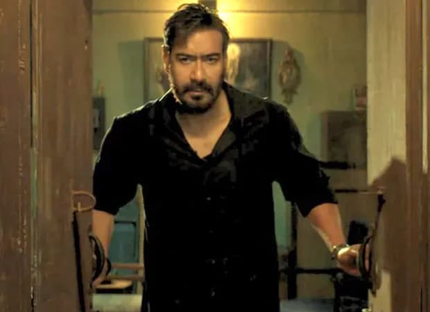 Ajay Devgn at a Drishyam 3 promotional event with a chart showing ticket sales surpassing 100,000.