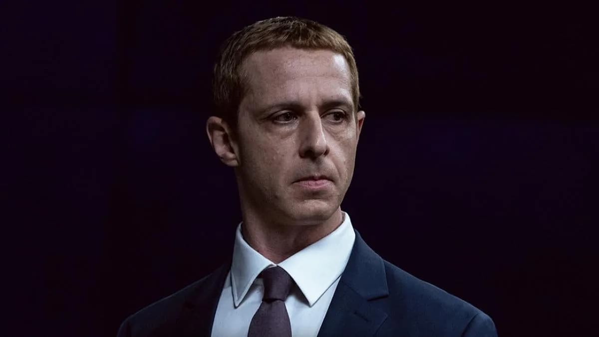 A dimly lit scene from The Social Reckoning, showing Mikey Madison in a tense expression, surrounded by digital screens.