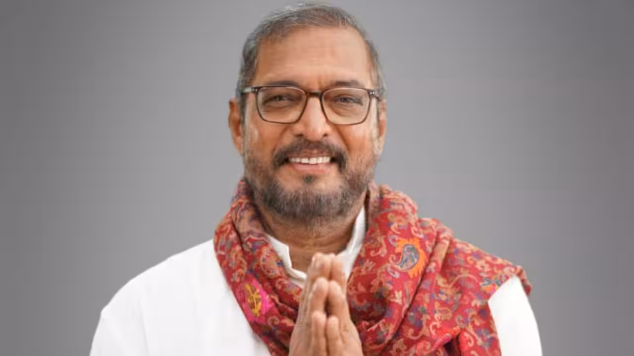 A black-and-white photo of Nana Patekar in profile, looking directly at the camera, wearing a dark jacket and white shirt.