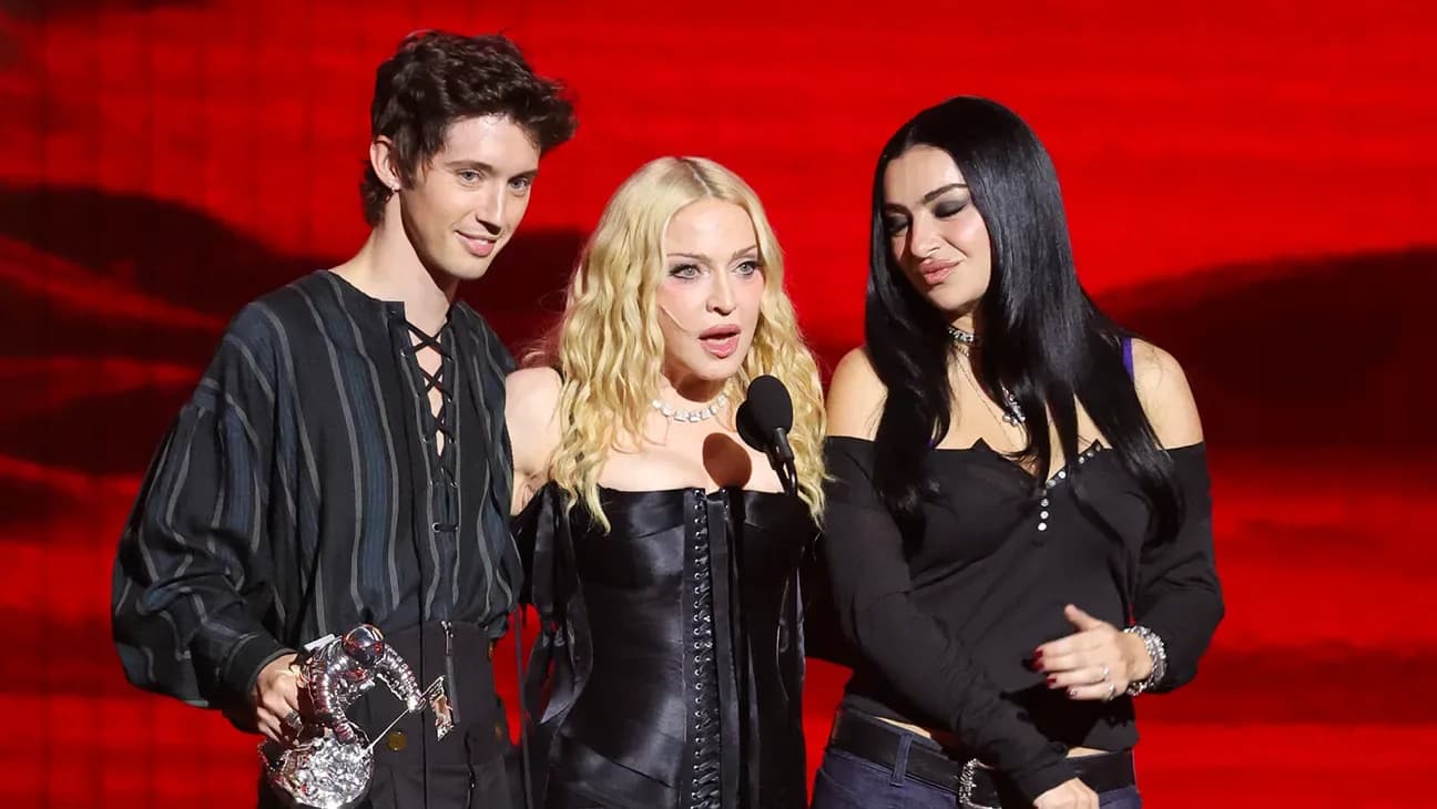 Madonna performing on a black piano with Sabrina Carpenter and Charli XCX at the 2026 MTV Video Music Awards