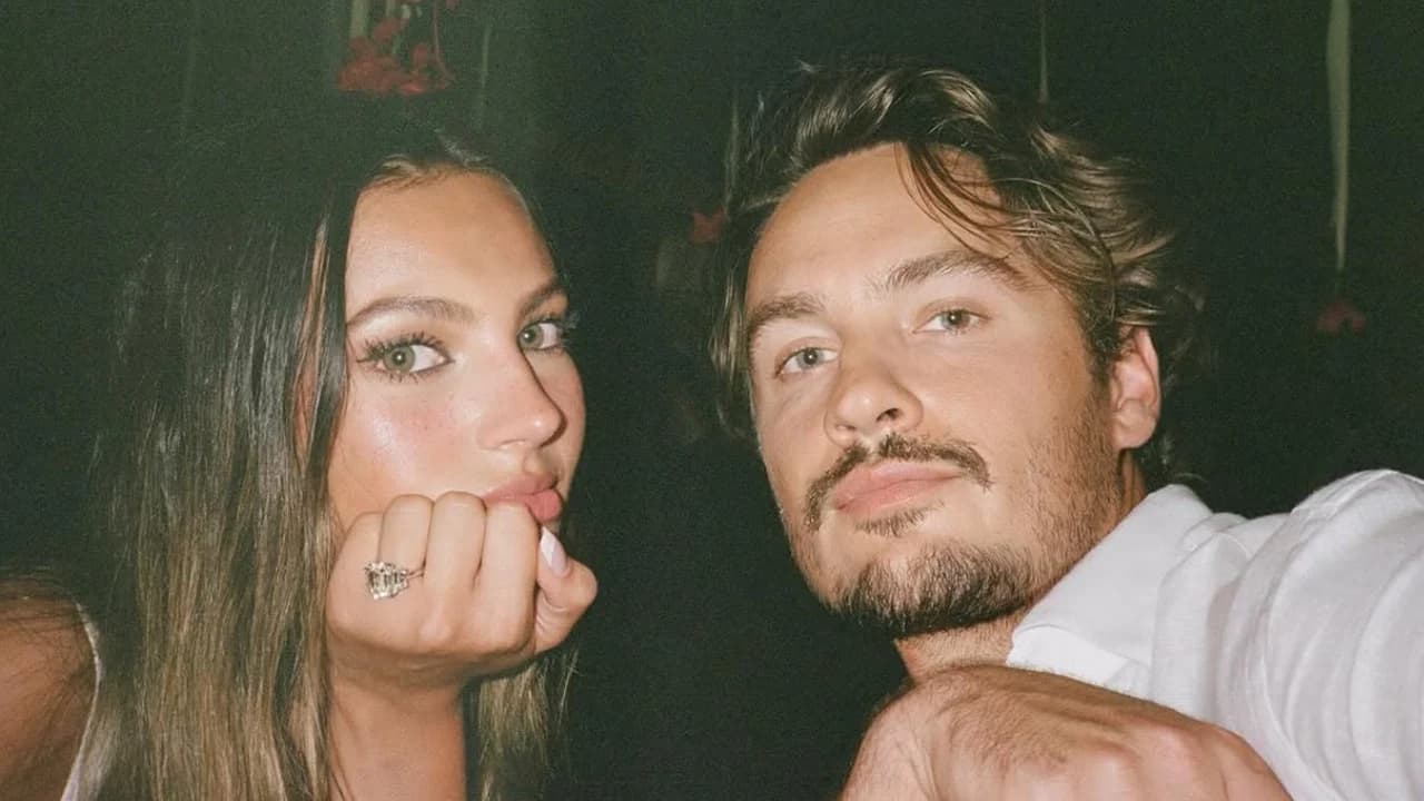 Brandon Thomas Lee and Katarina Demetriades embracing on a beach after their engagement in Indonesia.