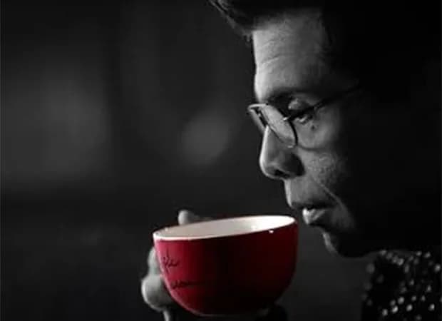 Karan Johar holding a coffee mug on the set of Koffee With Karan