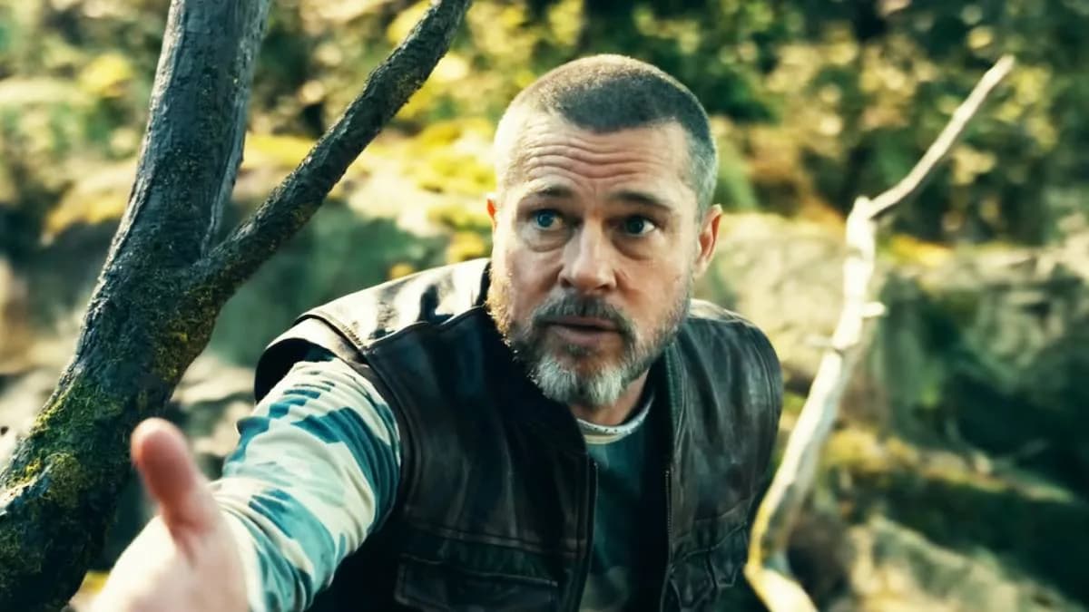Brad Pitt in a rugged survival outfit, standing in snow, looking into the distance.