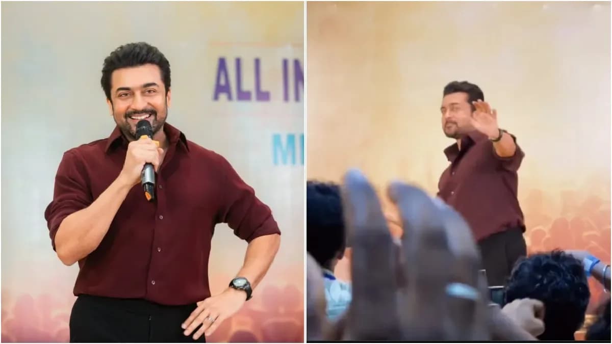 Actor Suriya speaking to a crowd of fans at a Chennai fan meet, gesturing passionately.