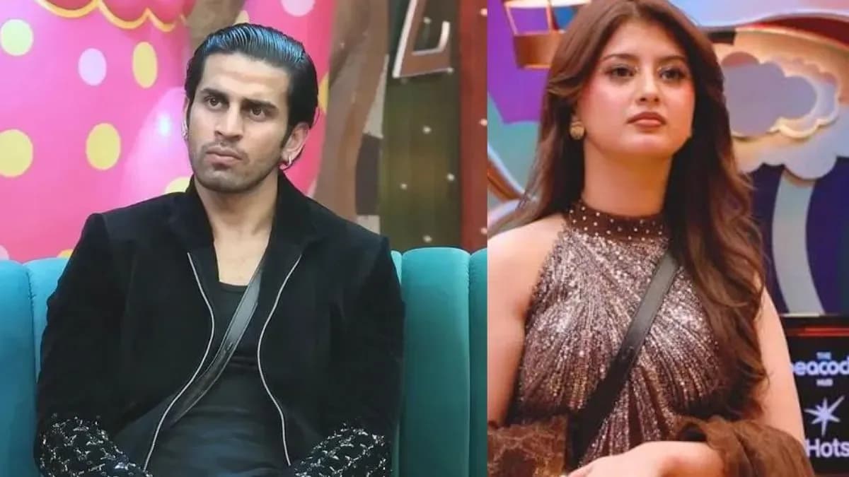 Kushal Tanwar (Gullu) standing still in the Bigg Boss house, expression neutral, as others react around him.