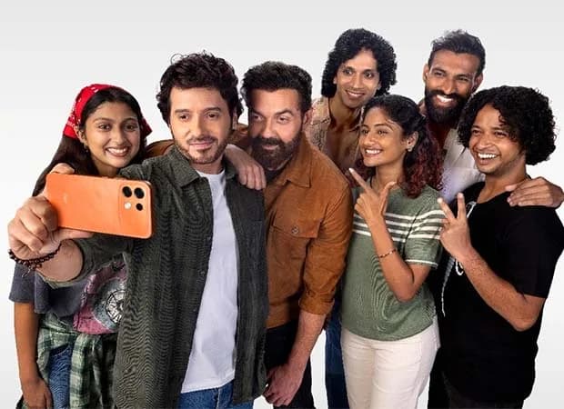 Bobby Deol and Divyenndu posing together in a vibrant, candid moment during an OPPO India campaign shoot