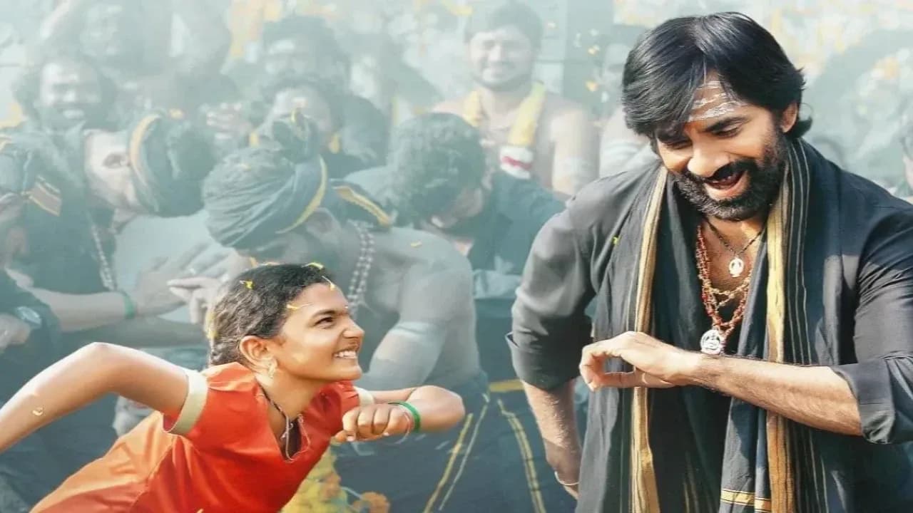 Ravi Teja posing with the Irumudi poster at the film's premiere event