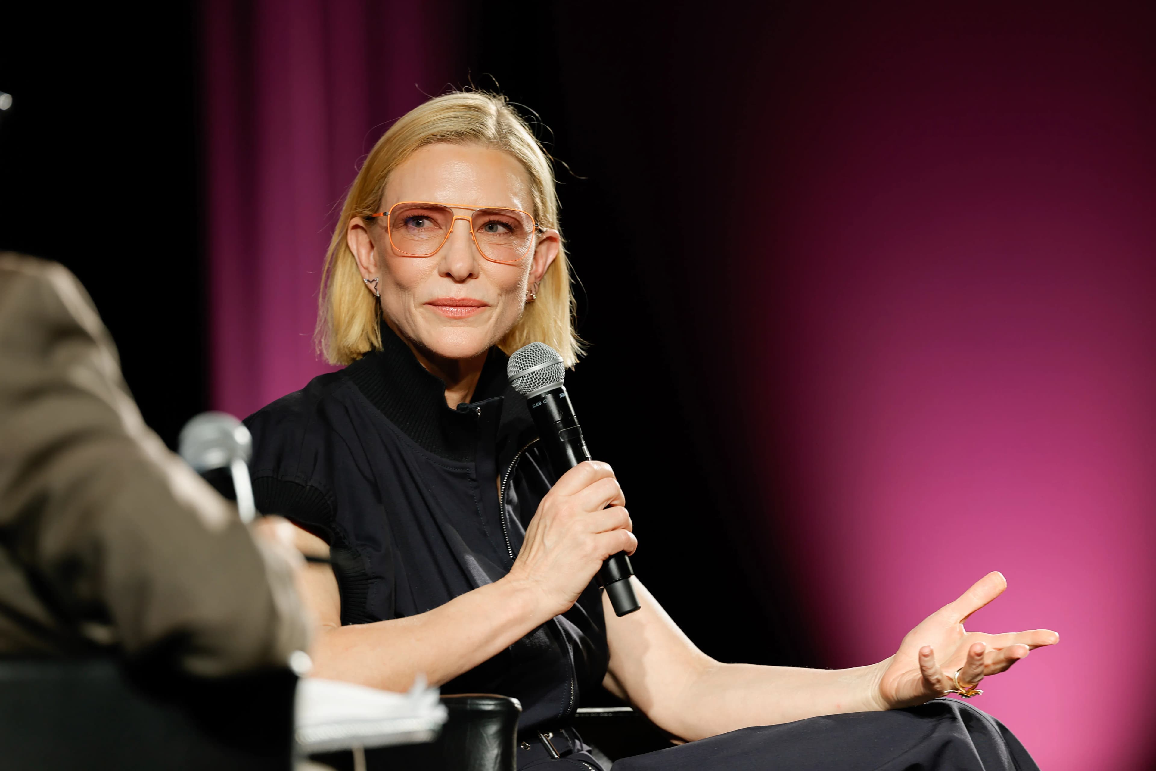 Cate Blanchett at a public appearance, smiling for photographers