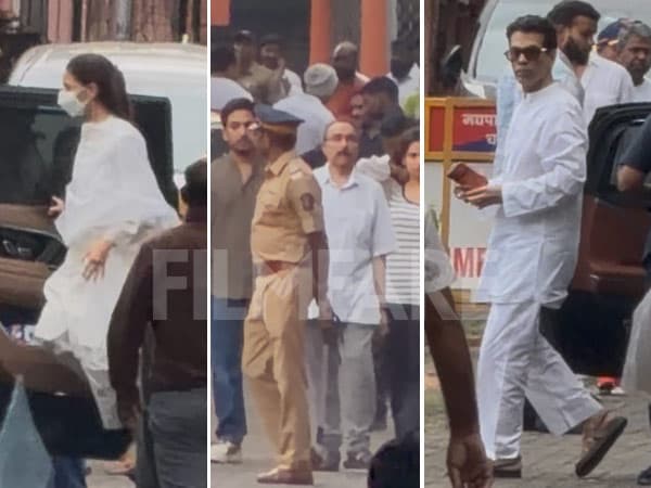 Shah Rukh Khan standing beside Rani Mukerji at the cremation site in Juhu, Mumbai, with other Bollywood personalities in the background